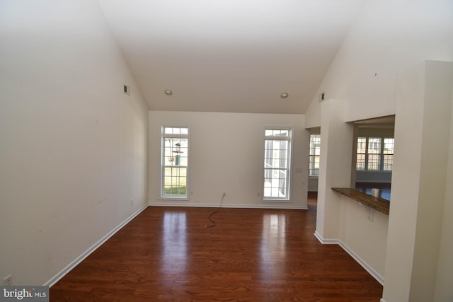 unfurnished living room with visible vents, high vaulted ceiling, baseboards, and wood finished floors