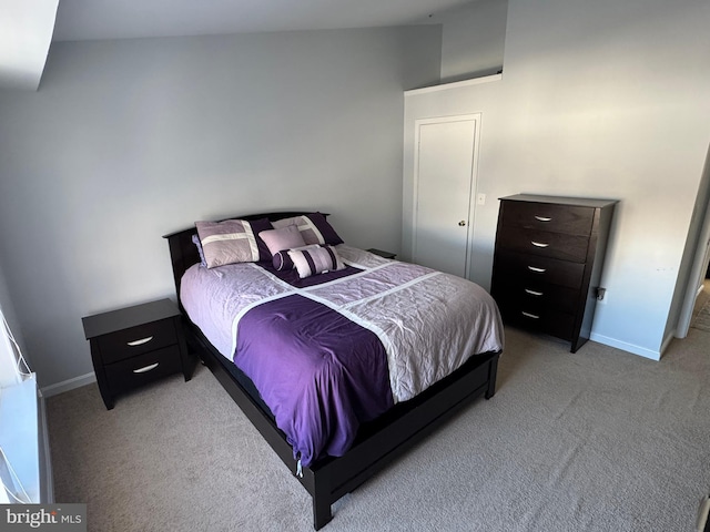 bedroom with baseboards and light colored carpet