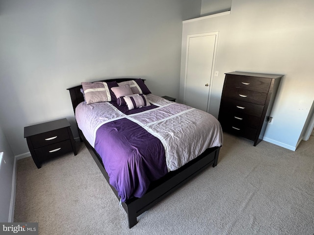 bedroom with light carpet and baseboards