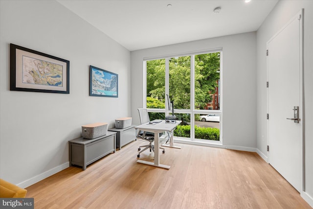 office space with light wood finished floors and baseboards