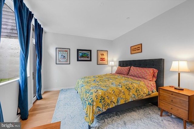 bedroom featuring light wood-type flooring and baseboards