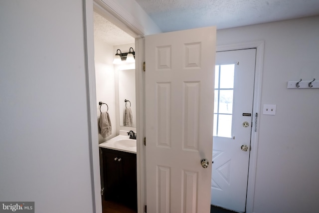 bathroom featuring a textured ceiling and vanity