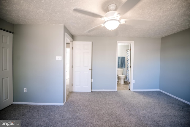 unfurnished bedroom with carpet, ceiling fan, a textured ceiling, and baseboards