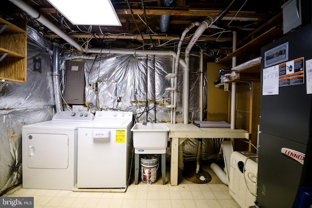 laundry room featuring washer and clothes dryer, heating unit, a sink, laundry area, and electric panel