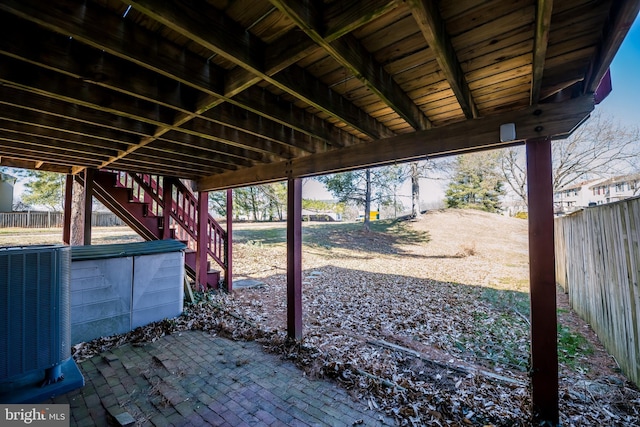 view of patio / terrace featuring fence private yard, central AC, and stairway