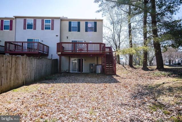 back of property featuring stairway, fence, and a wooden deck