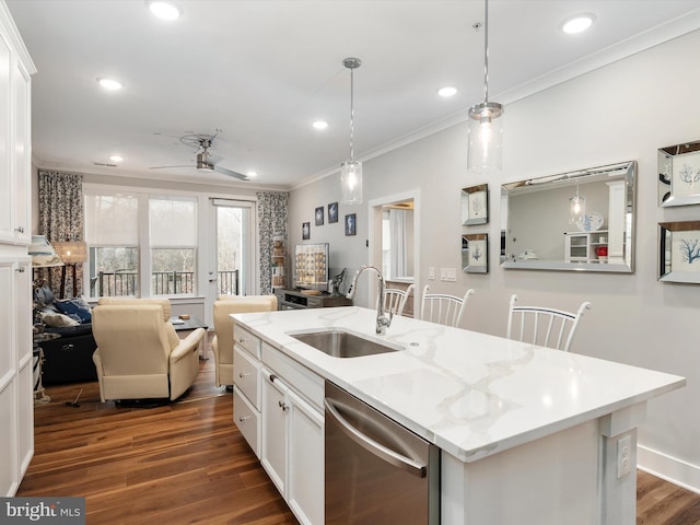 kitchen featuring a sink, white cabinetry, dishwasher, an island with sink, and decorative light fixtures