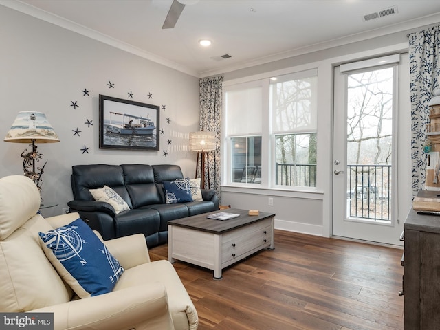 living room featuring a ceiling fan, dark wood finished floors, visible vents, and crown molding