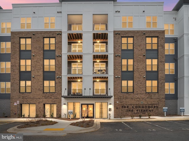 view of building exterior with uncovered parking