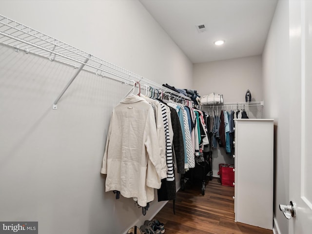 walk in closet featuring dark wood-style flooring and visible vents