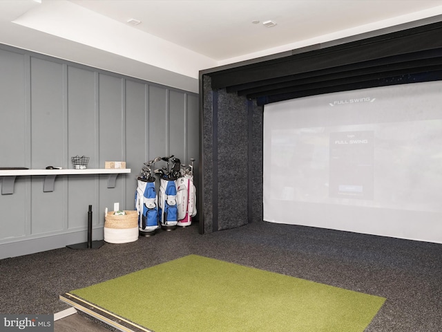 playroom featuring golf simulator and a decorative wall