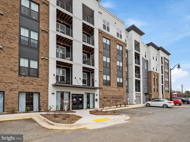 view of building exterior with uncovered parking