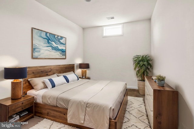 bedroom featuring light colored carpet and visible vents