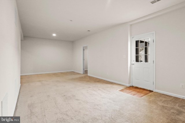 spare room with light carpet, visible vents, baseboards, and recessed lighting