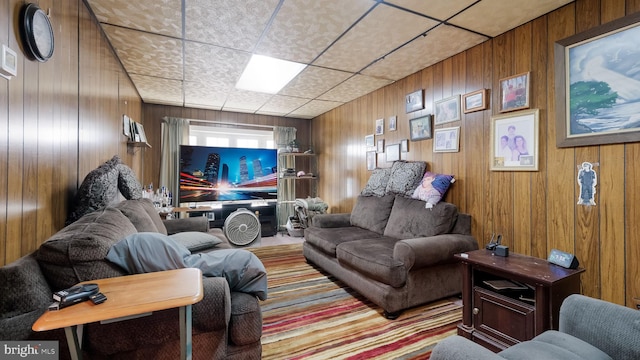 living area featuring wood walls