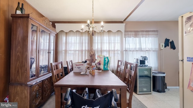 dining area with beverage cooler, a chandelier, and light tile patterned flooring