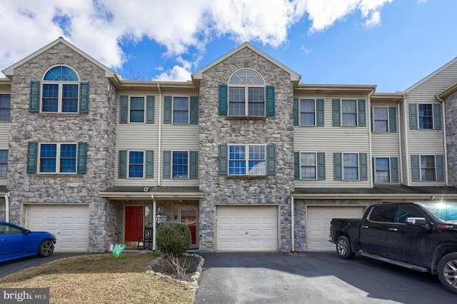 view of property with driveway and an attached garage