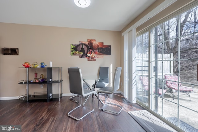 interior space featuring baseboards and wood finished floors