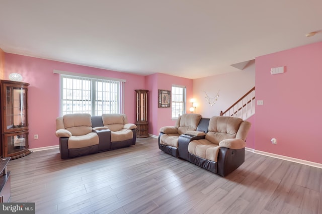 living room with baseboards, stairway, and wood finished floors