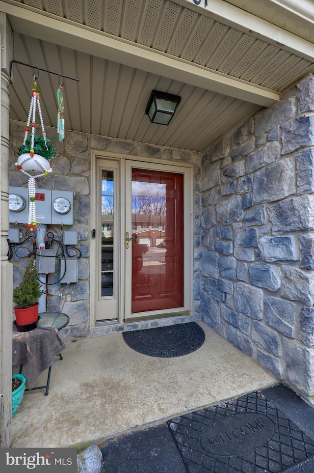 doorway to property with stone siding