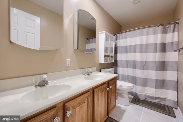 full bathroom with toilet, double vanity, visible vents, and a sink