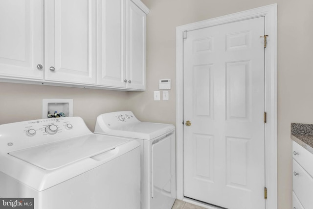 laundry room featuring cabinet space and washing machine and clothes dryer