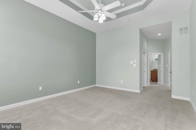 empty room featuring ceiling fan, baseboards, visible vents, and light carpet