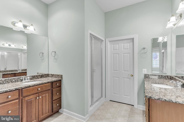 bathroom featuring tile patterned floors, two vanities, and a sink