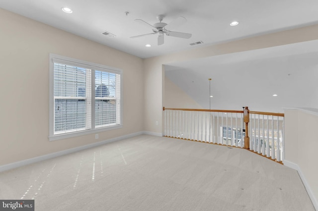 spare room featuring visible vents, a ceiling fan, recessed lighting, carpet flooring, and baseboards