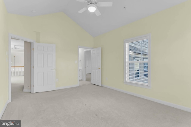 unfurnished bedroom with carpet flooring, baseboards, and lofted ceiling