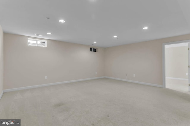 basement with recessed lighting, baseboards, and light carpet