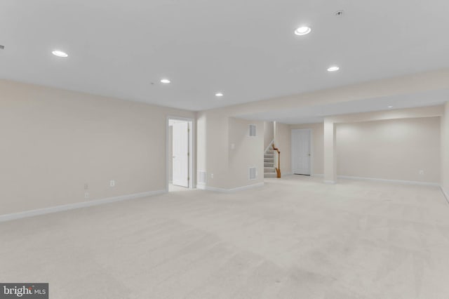 finished basement featuring recessed lighting, stairway, baseboards, and visible vents