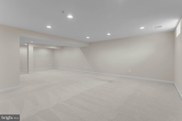 finished basement featuring light colored carpet, recessed lighting, visible vents, and baseboards