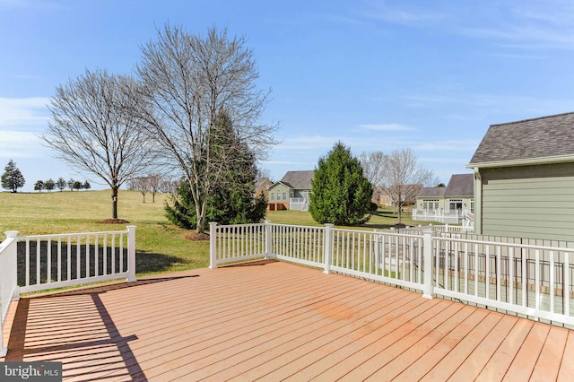 wooden terrace with a lawn and fence