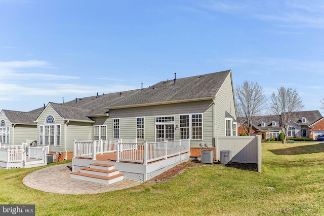 back of house featuring a wooden deck, a lawn, central AC unit, and brick siding