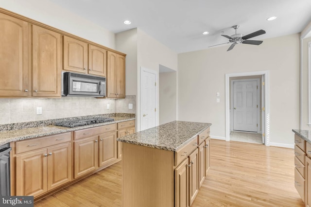 kitchen with gas cooktop, light stone countertops, recessed lighting, light wood-style floors, and tasteful backsplash