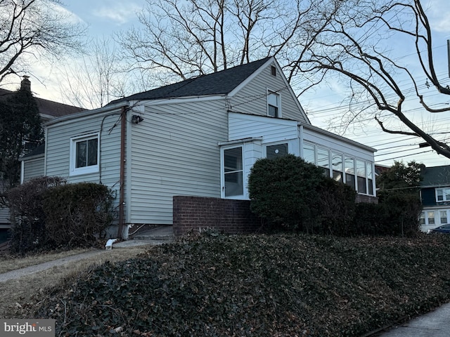 view of side of home with brick siding