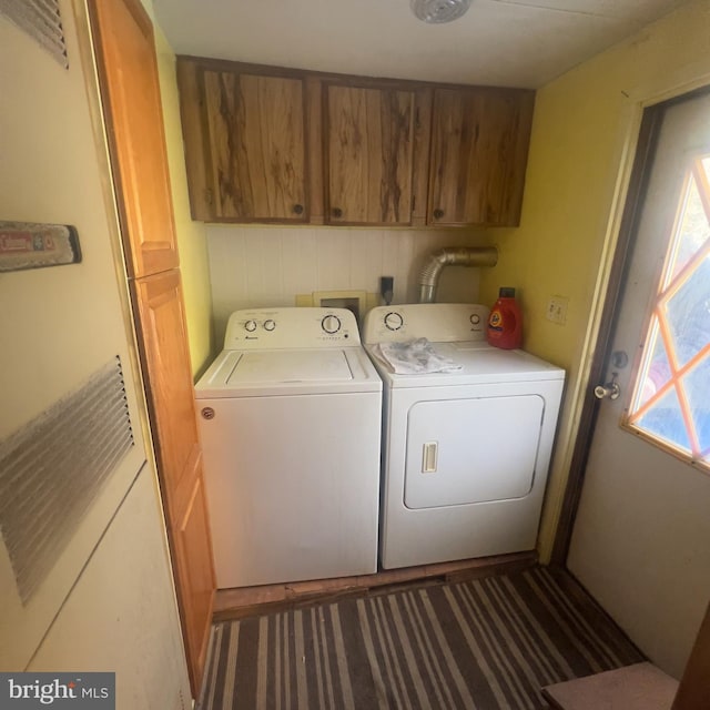 washroom with cabinet space and washing machine and clothes dryer