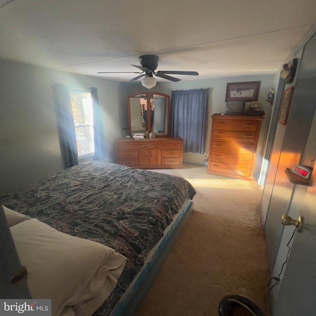 bedroom featuring a ceiling fan and light colored carpet