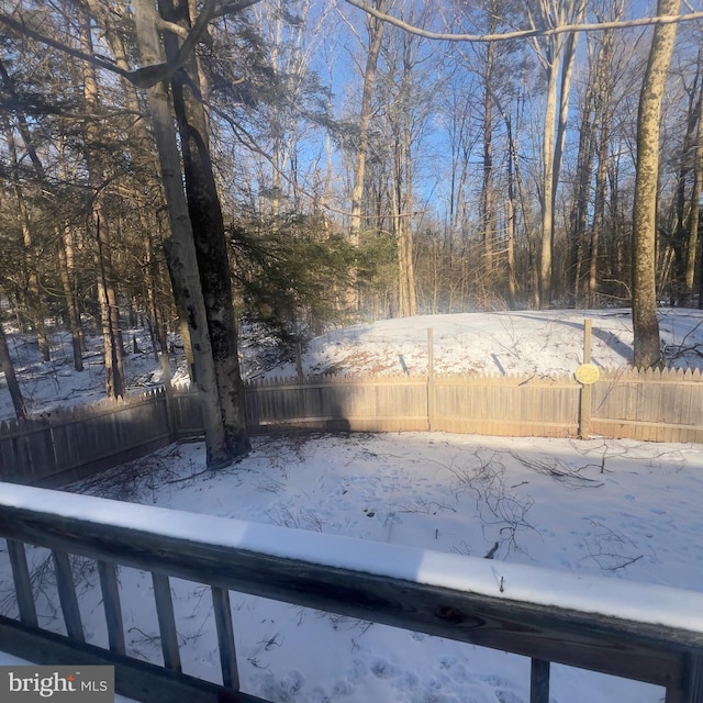 yard covered in snow with fence
