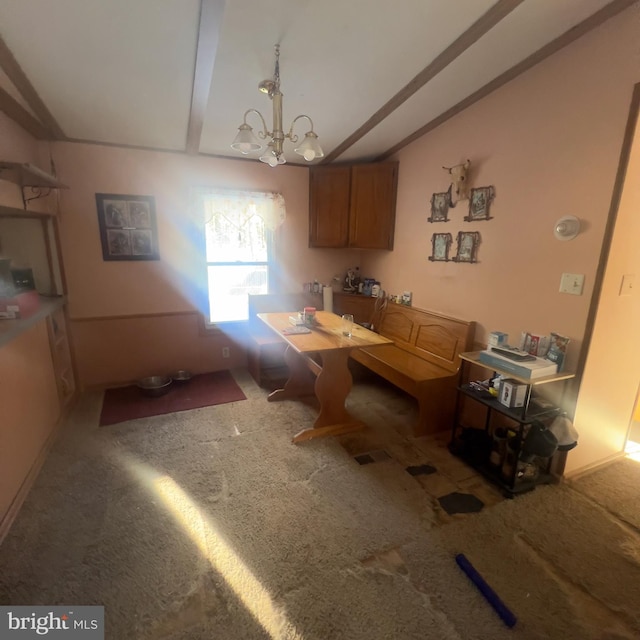 carpeted dining space featuring lofted ceiling with beams and an inviting chandelier