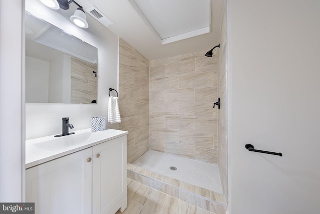 bathroom featuring a stall shower, vanity, and visible vents