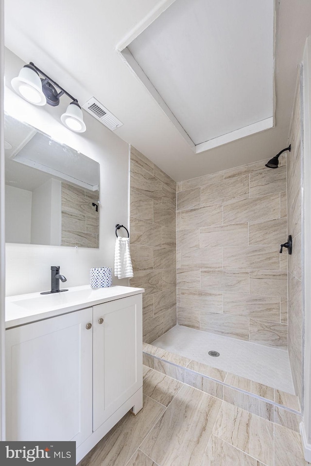 bathroom featuring vanity, visible vents, and a shower stall