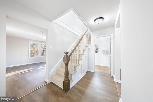 stairs with baseboards and wood finished floors