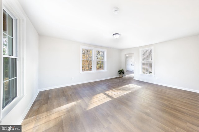 unfurnished room featuring baseboards and wood finished floors