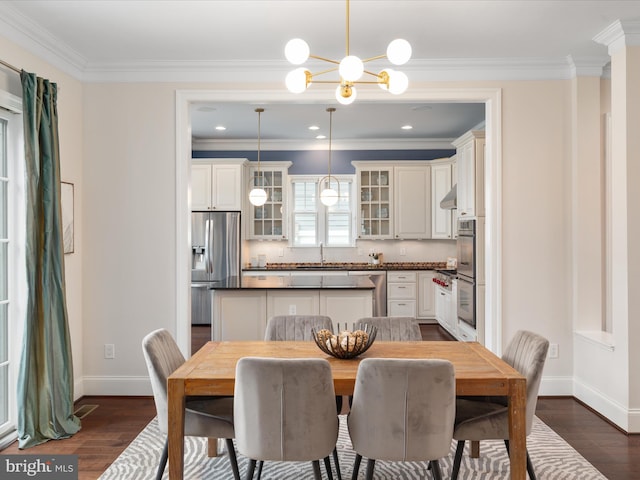 dining area featuring baseboards, ornamental molding, dark wood-style floors, and an inviting chandelier