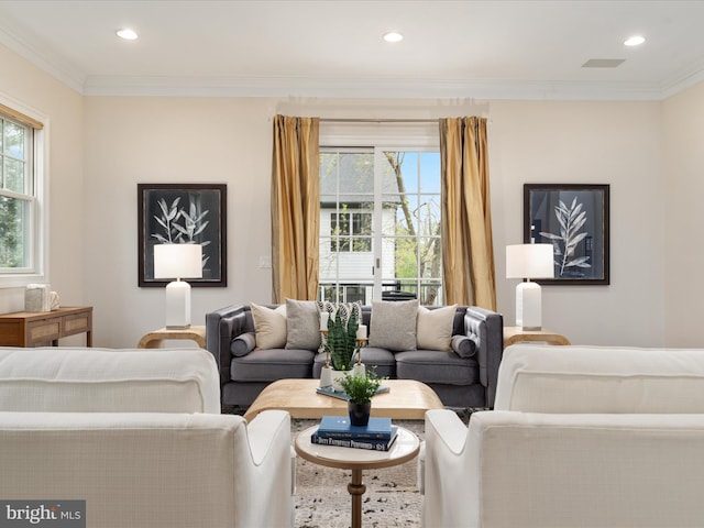 living area with recessed lighting and ornamental molding