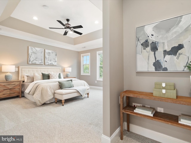 bedroom featuring recessed lighting, carpet floors, a tray ceiling, and baseboards
