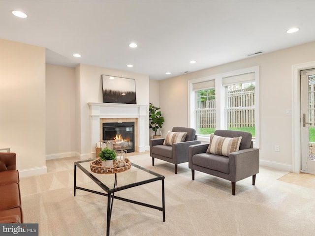 living area featuring light carpet, visible vents, recessed lighting, baseboards, and a fireplace