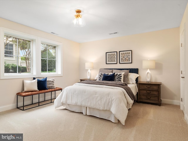 bedroom featuring carpet floors, visible vents, and baseboards